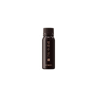 a black bottle of VITALBEAUTIE Red Ginseng Gold Extract Ampoule on white background
